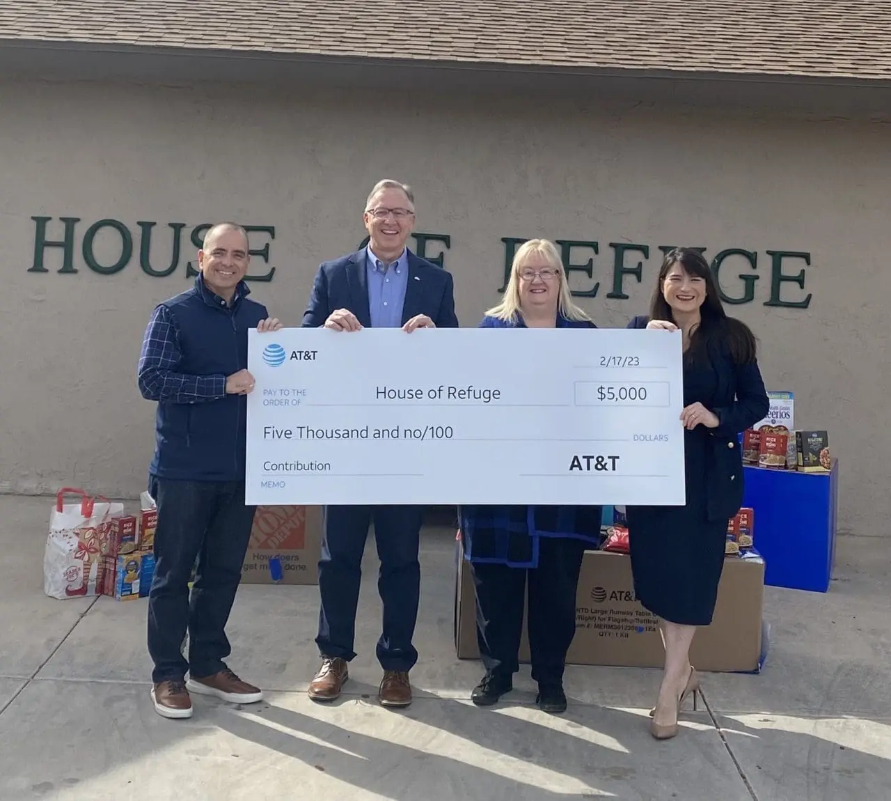 People holding a giant check