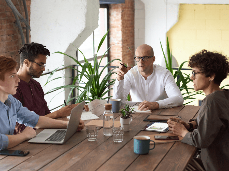 A group of people sitting around a table having a conversation