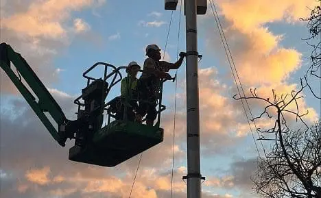 Technicians working on a pole