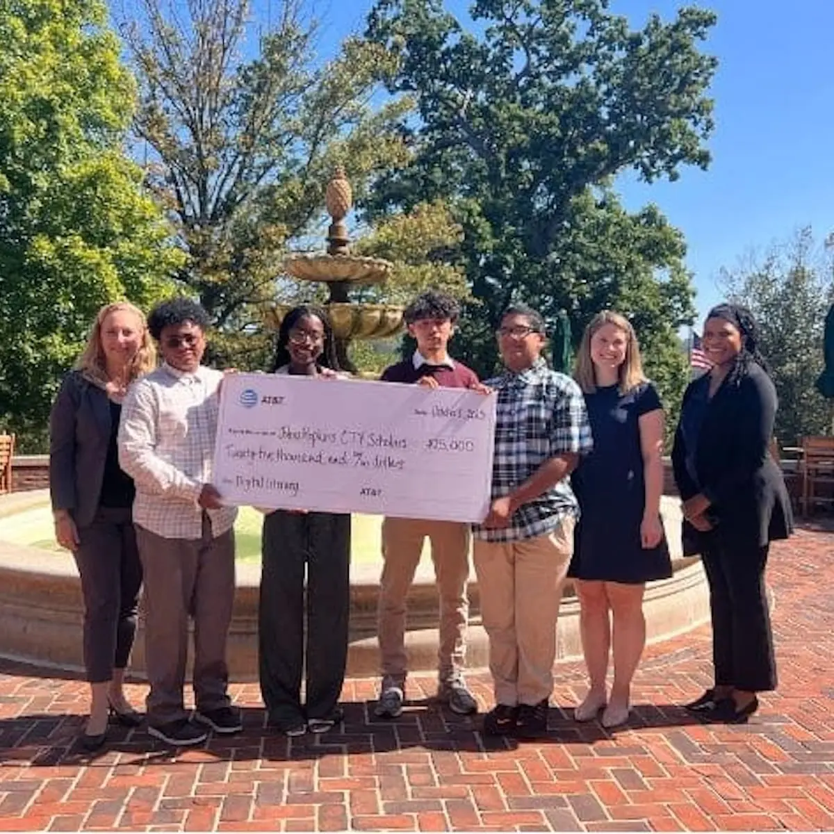 People holding a giant check