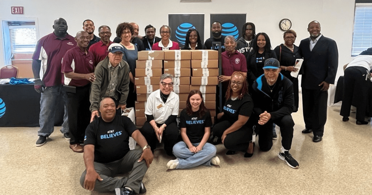 group of people sitting in front of boxes