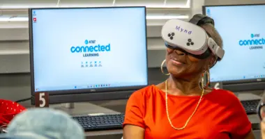 An older woman wears a VR headset