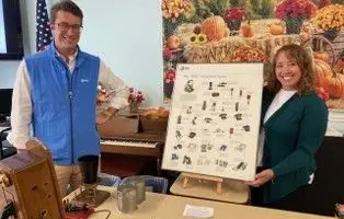 Employees smiling with display