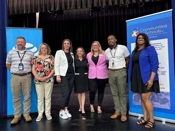 People on stage at an AT&T event smiling at the camera