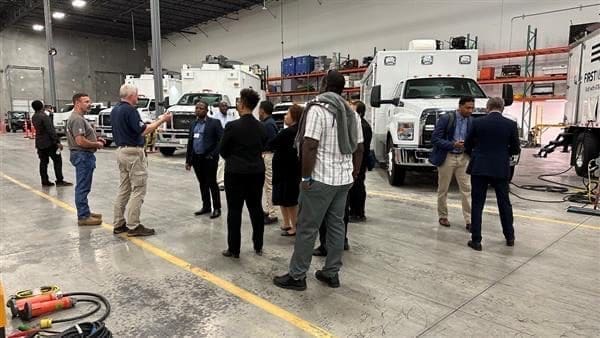 People receiving training next to AT&T trucks