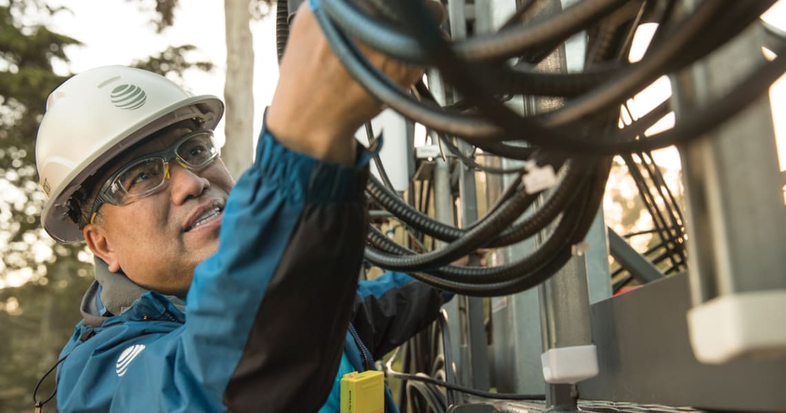 Man working on AT&T equipment.