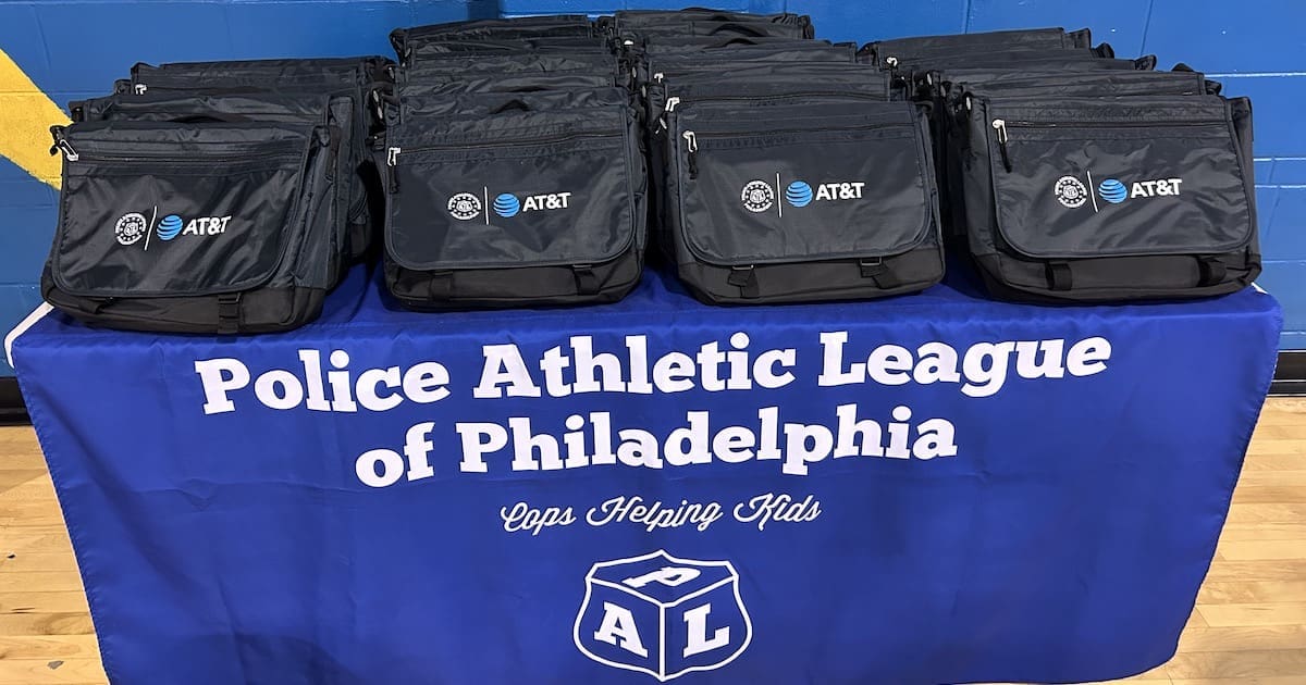 an image of AT&T backpacks on a table with a Police of Athletic League of Philadelphia table cloth