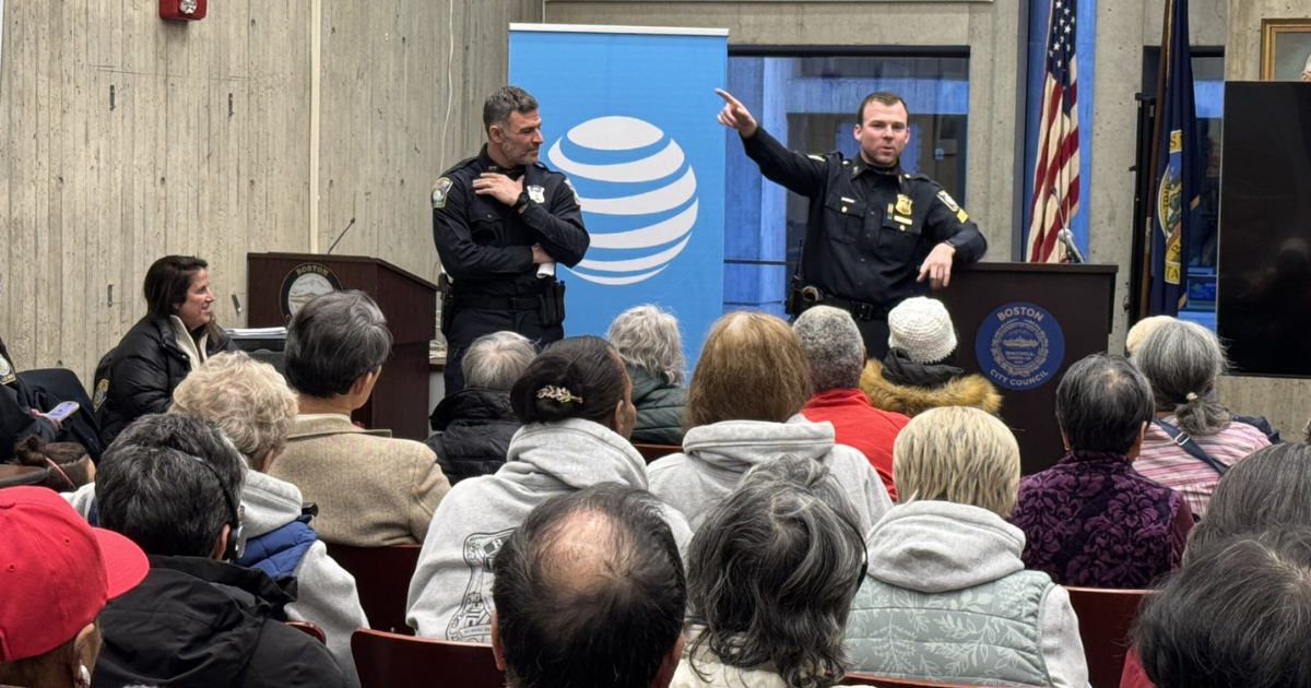 Boston police officers giving a presentation to a crowd of people