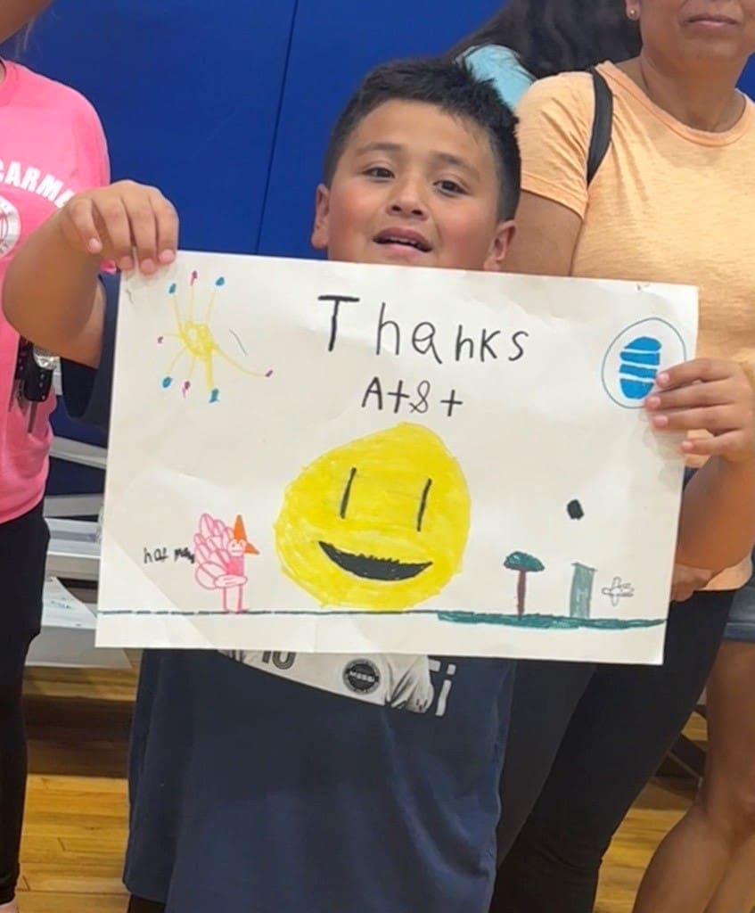 Student IL Connectivity Week holding "thanks AT&T" sign 
