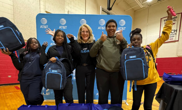 Group of people smiling while holding backpacks