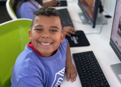 A little boy smiling at the camera