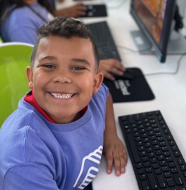 A little boy smiling at the camera