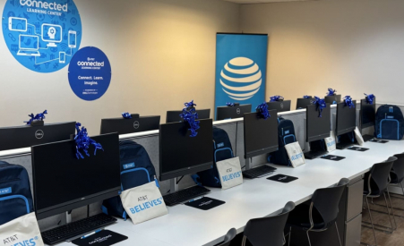 A computer lab with computers that have bows on them