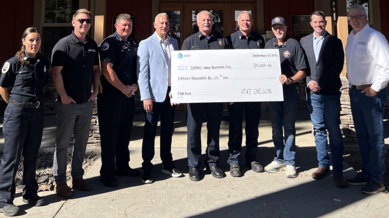 A group holding a ceremonial check