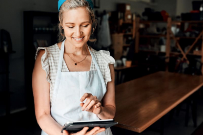 Woman in an apron using a tablet