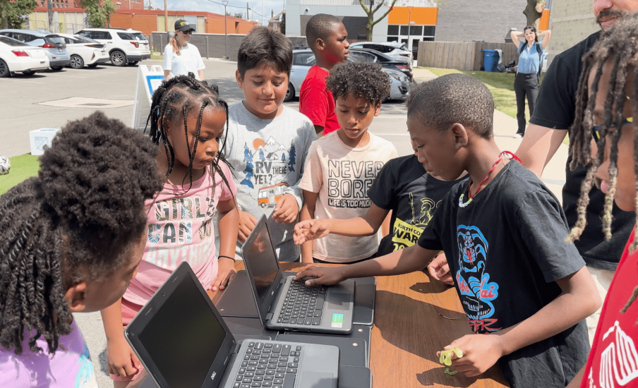 Kids with computers at laptop donation event