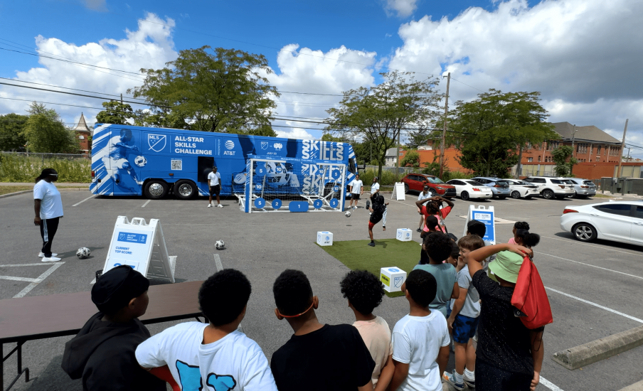 Children standing in a group in front of a goal