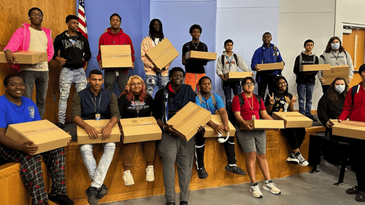 People with laptop boxes