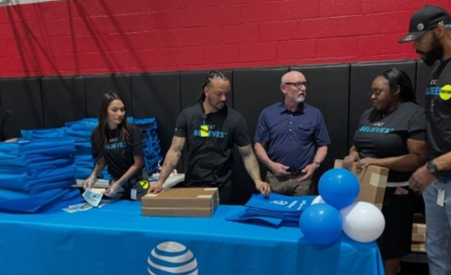 People sitting behind an AT&T desk.