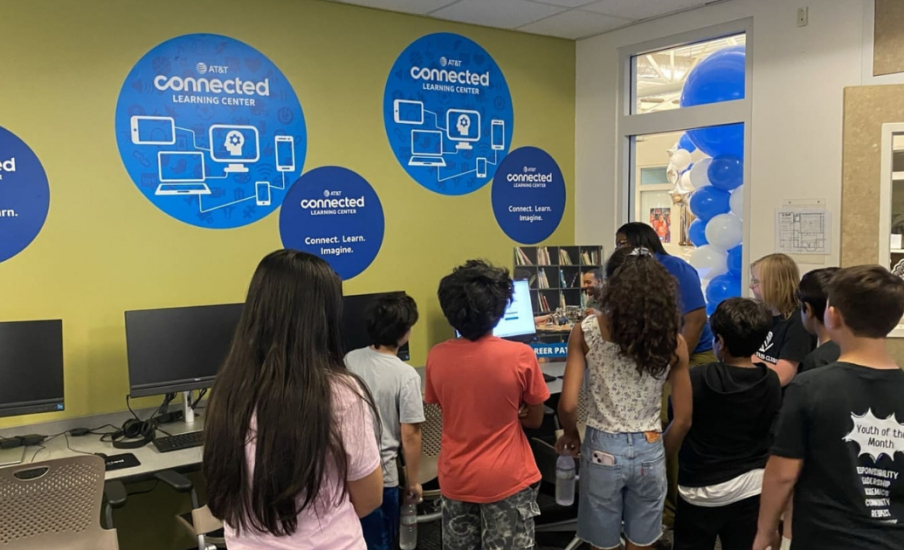 Kids gathered around a computer