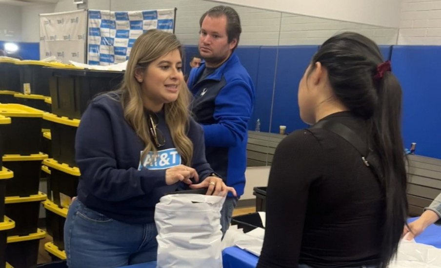 A person talking to another person at a fold out table