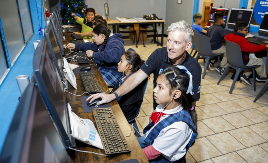 A man showing a child something on a computer