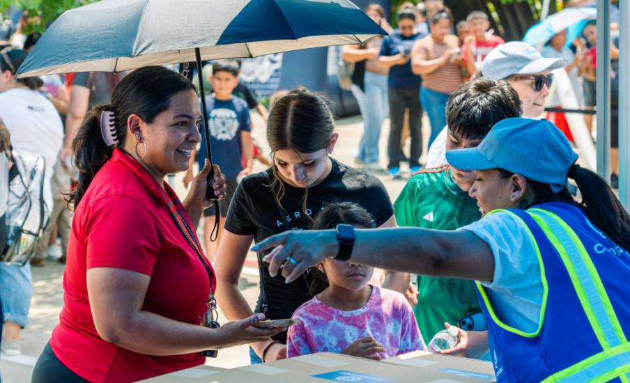 a family standing in front of a table of boxes.