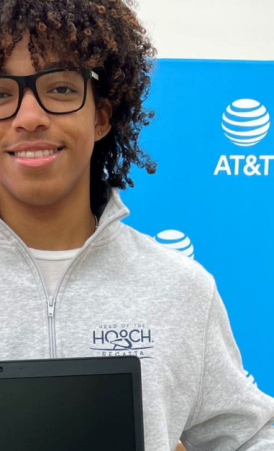 A boy holding a laptop