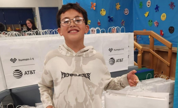 Young boy smiling with bag