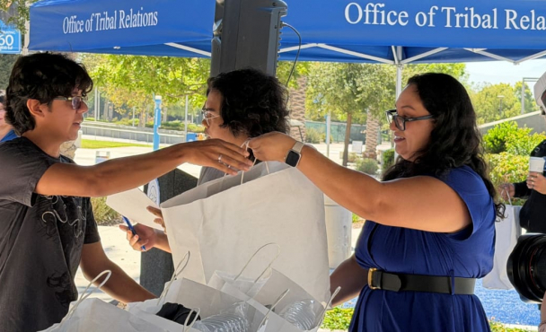 Woman handing out bag at event