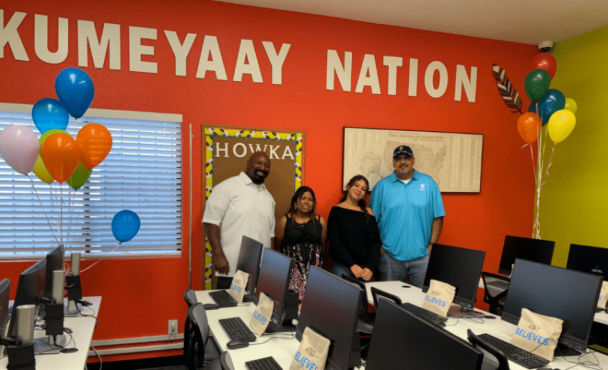 Three people in front of a banner that says "Kumeyaay Nation"