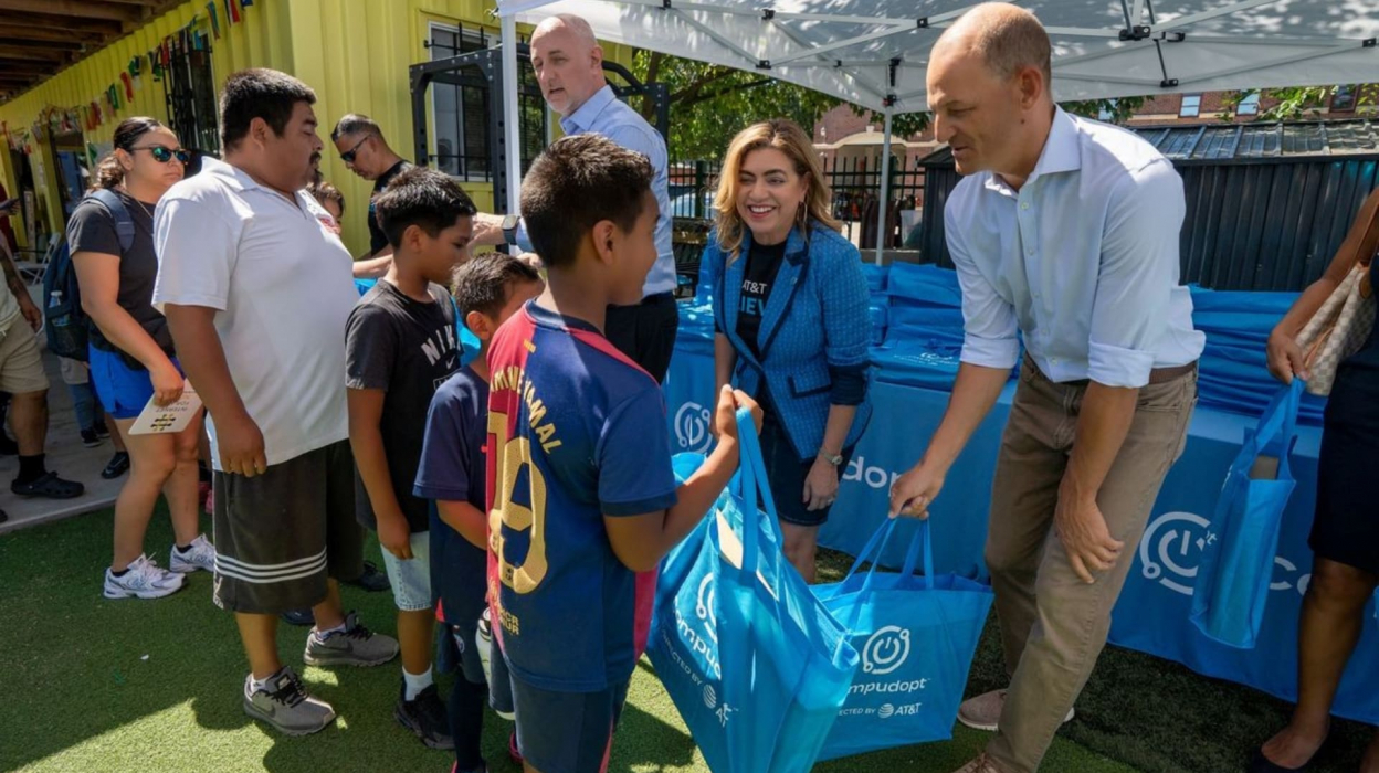 Person handing out bag at AT&T event