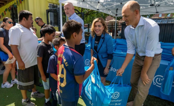 Adults handing out materials at AT&T event