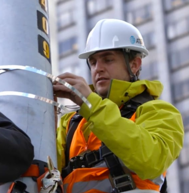 AT&T employee working on pole