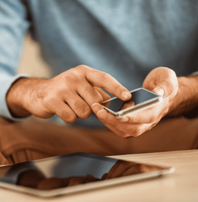 Close up of someone's hands holding a cell phone