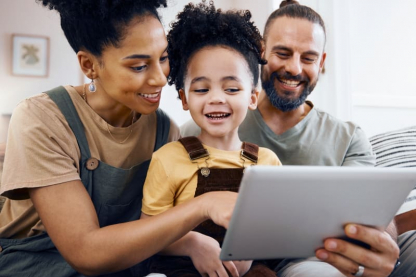 A family sitting together looking at a tablet