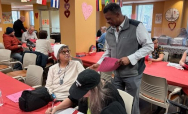 Man talking to elderly woman at event