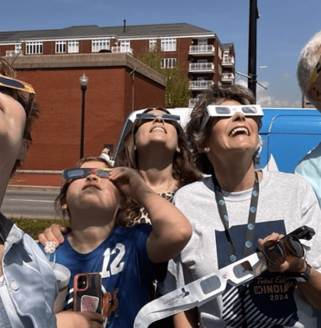 People looking at the eclipse with glasses on