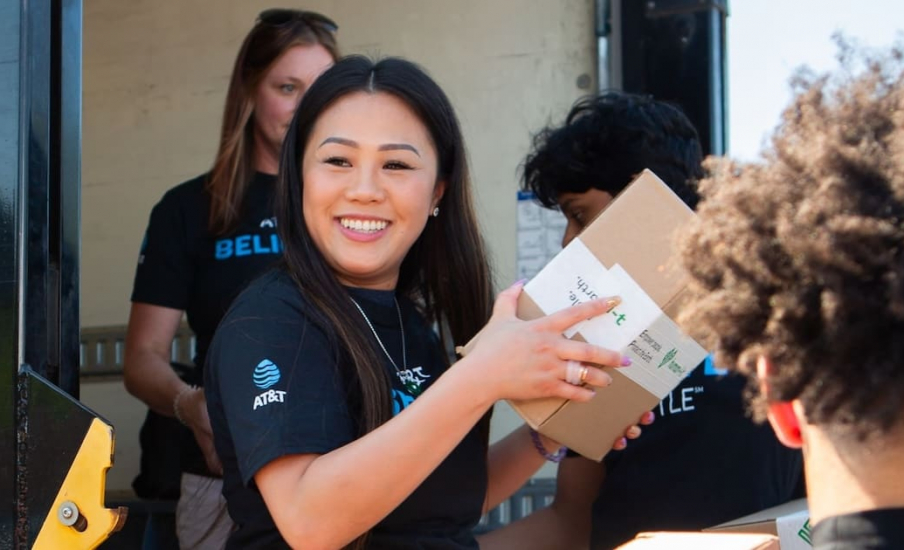An AT&T employee holding a box
