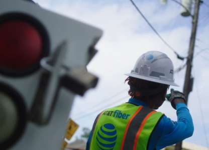AT&T utility worker at work on a telephone pole.
