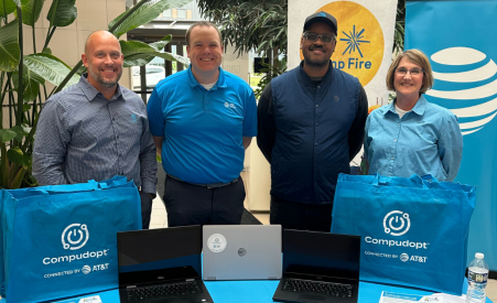 Four people smiling at an AT&T event.