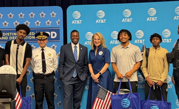 People smiling in front of AT&T backdrop