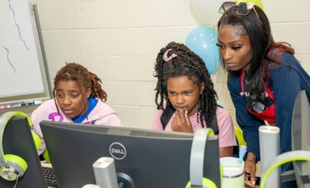 Children looking at a computer monitor
