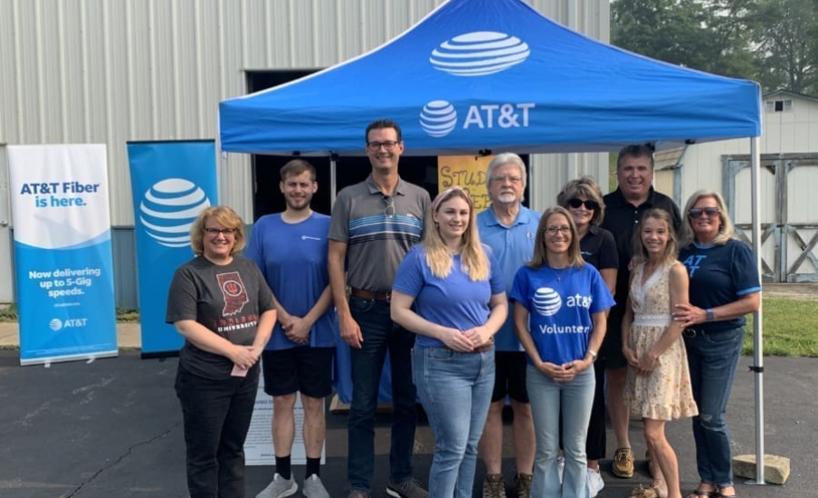 People standing under an AT&T tent