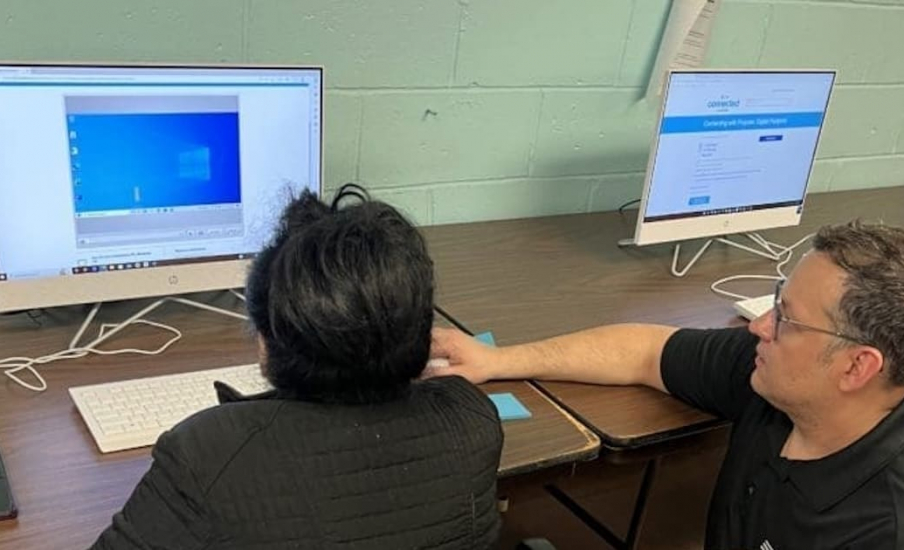 Someone showing someone how to use a computer