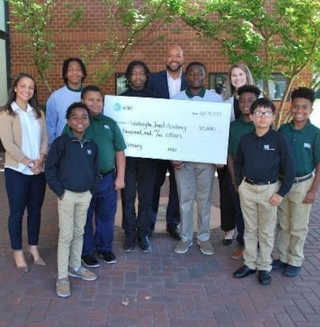 People holding a giant check