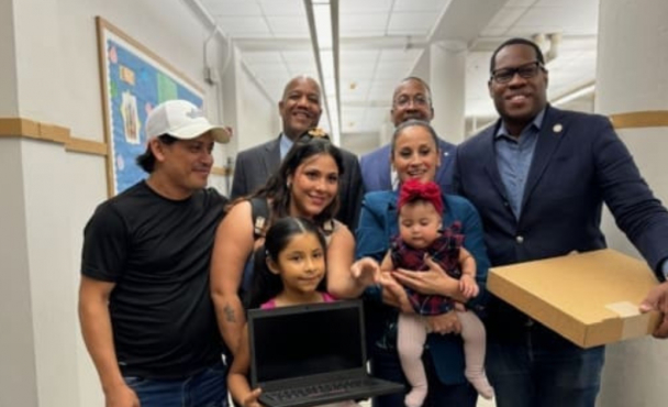 Family holding a laptop