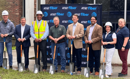 People with hardhats and shovels standing in front of an AT&T Fiber sign