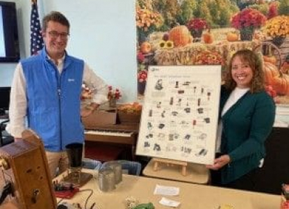 Employees smiling with display