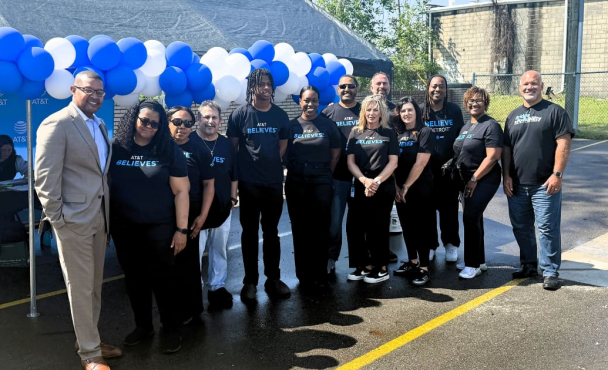 Group smiling in front of balloons.